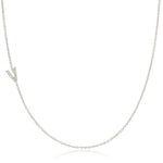 A white gold necklace with a letter V pave charm on a white background.