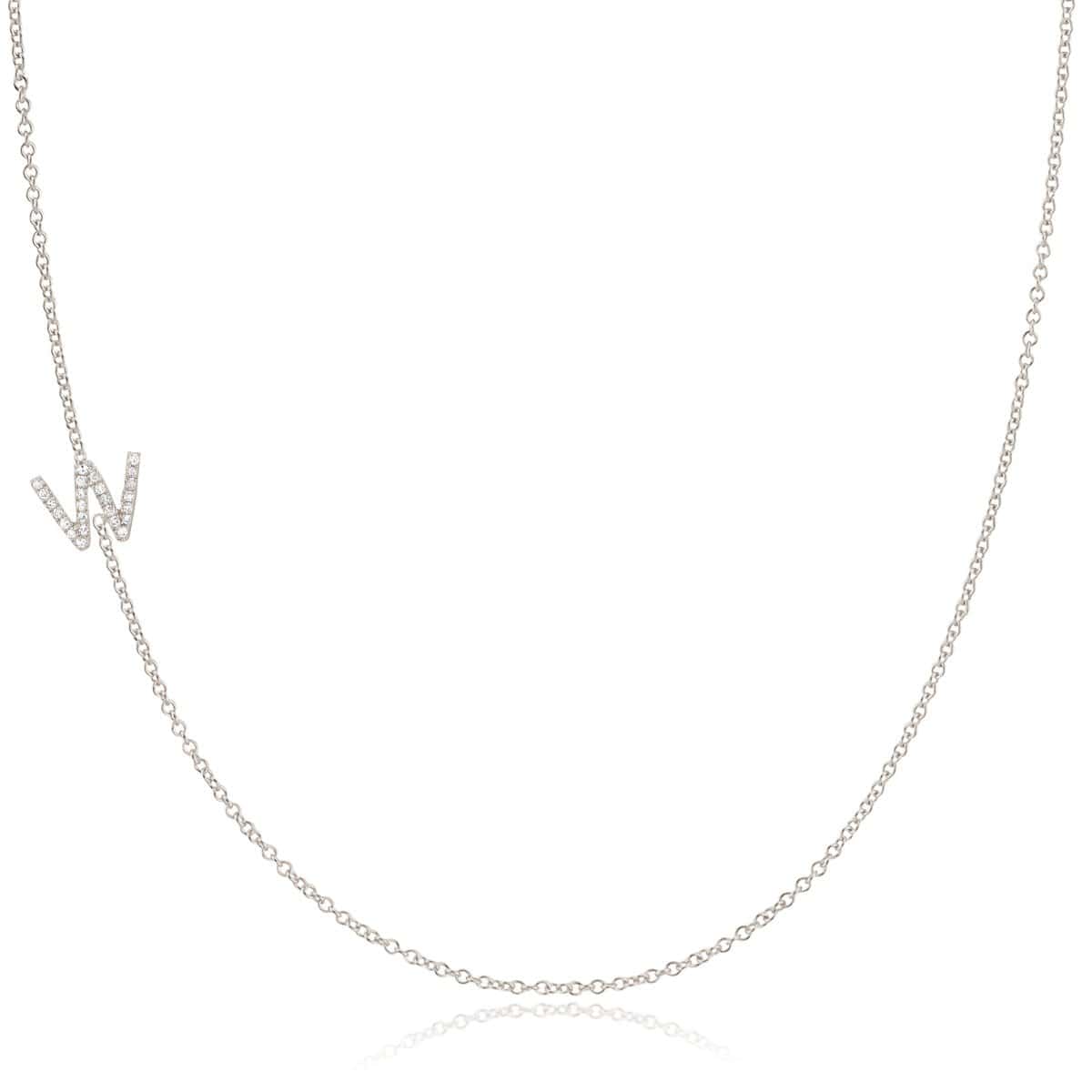 A white gold necklace with a letter W pave charm on a white background.