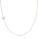 A white gold necklace with a letter W pave charm on a white background.