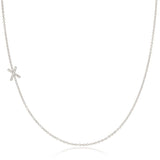 A white gold necklace with a letter X pave charm on a white background.