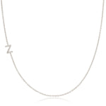 A white gold necklace with a letter Z pave charm on a white background.