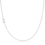 A white gold necklace with a letter Z pave charm on a white background.