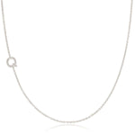 A white gold necklace with a letter Q pave charm on a white background.
