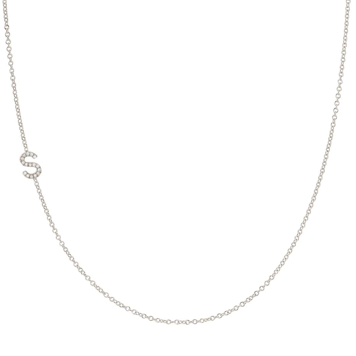 A white gold necklace with a letter S pave charm on a white background.