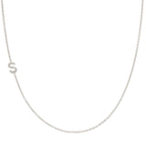 A white gold necklace with a letter S pave charm on a white background.