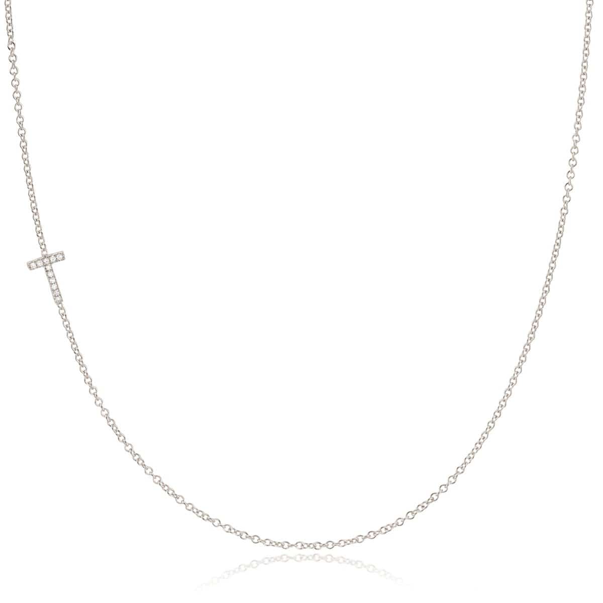 A white gold necklace with a letter T pave charm on a white background.