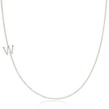 A white gold necklace with a W letter charm on a white background. 