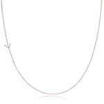 A white gold necklace with a Y letter charm on a white background. 
