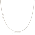 A white gold necklace with a Z letter charm on a white background. 