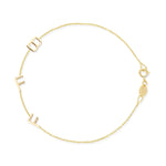 A yellow gold Custom Gold Bracelet - 3 Letters (B, F and F) on a white background. 