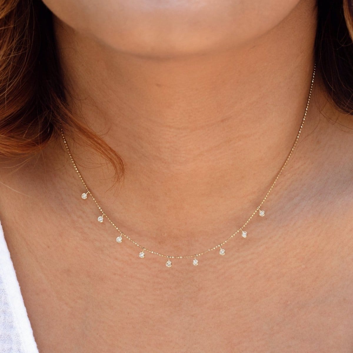 A close-up of a neck wearing a Stardust Diamond Necklace. 