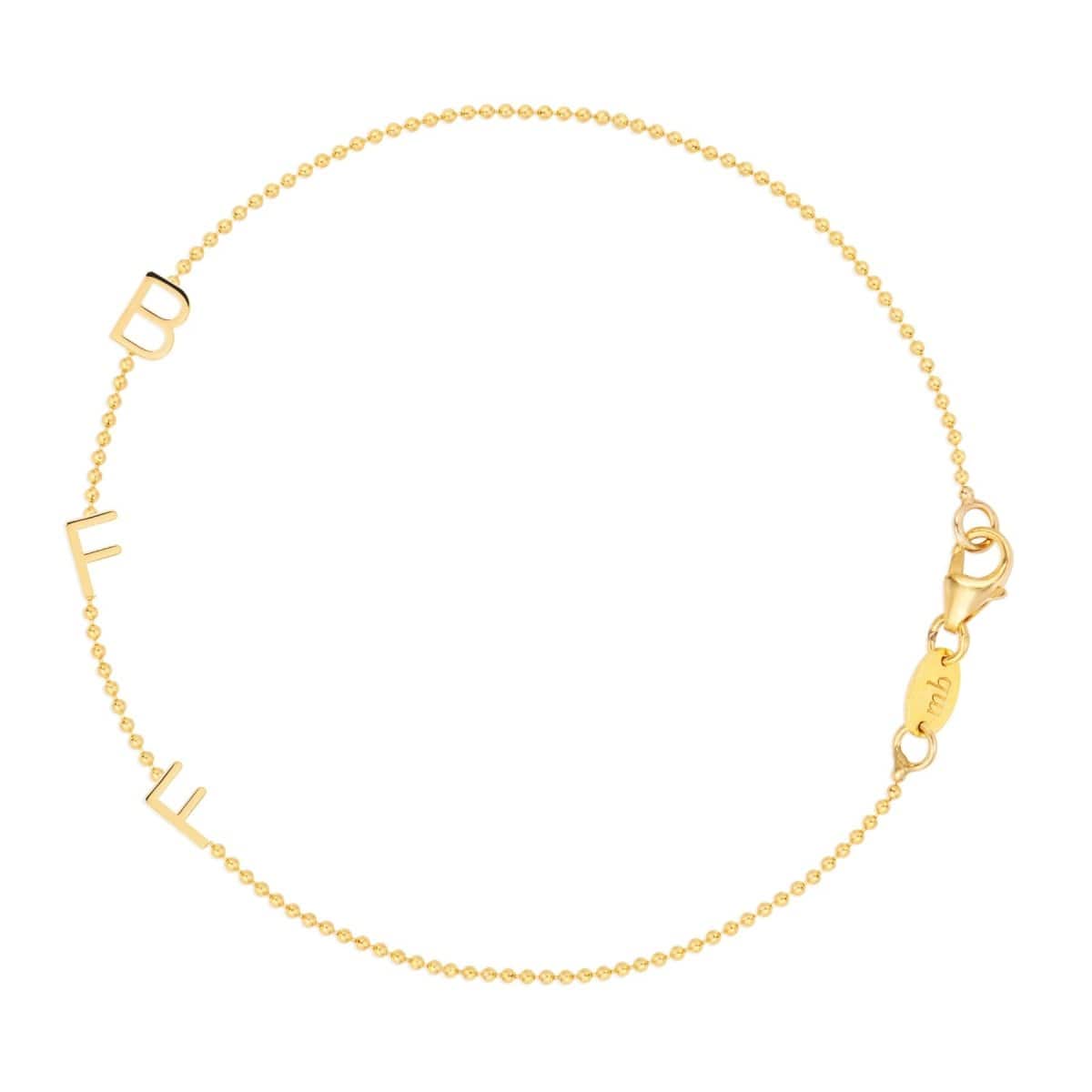 A yellow gold BFF Bracelet in a beaded chain bracelet on a white background. 