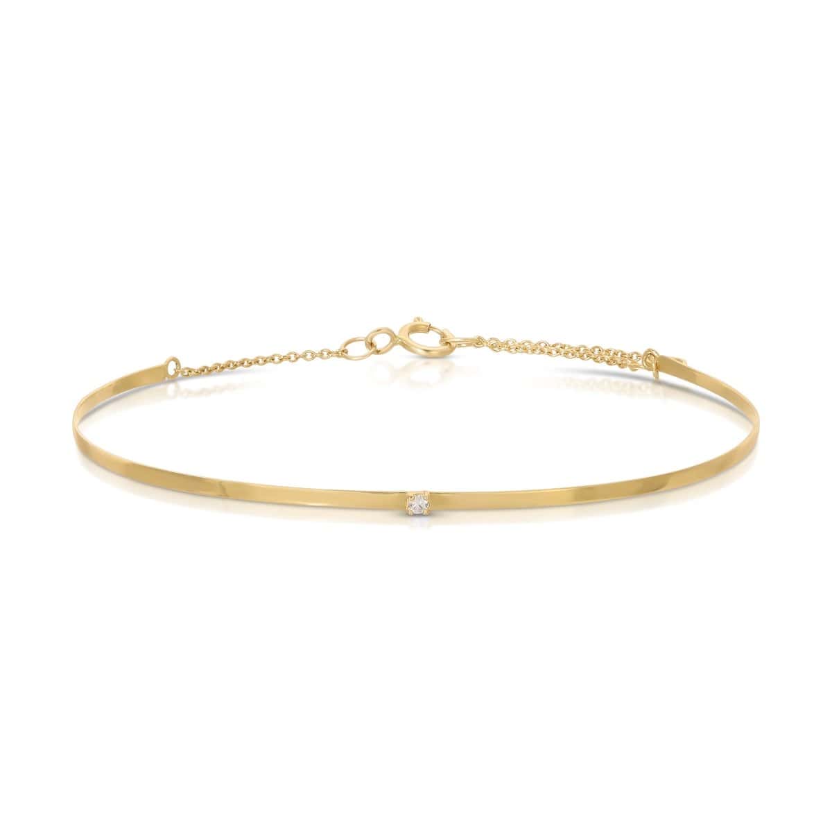An Off the Cuff Bracelet in yellow gold on a white background. 