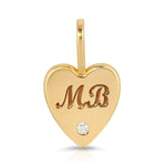 An Engraved Heart Charm on a white background. 