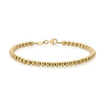 A Bubble Bracelet - Large in yellow gold on a white background. 