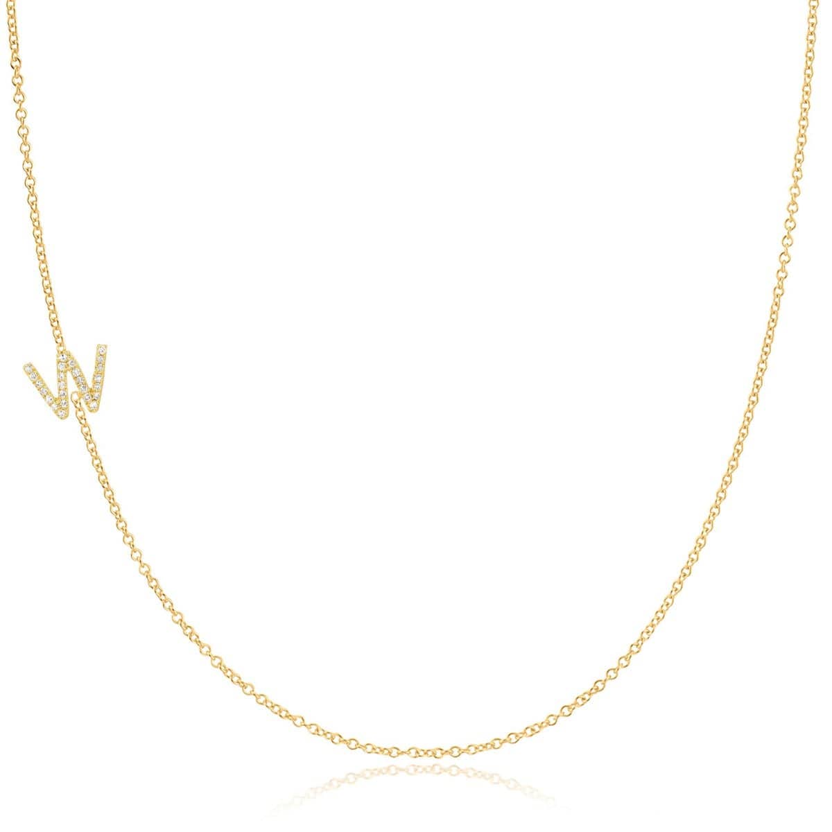 A yellow gold necklace with a pave letter W charm on a white background. 