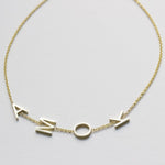 A yellow gold Custom Gold Bracelet – 4 Letters with the letters A, M, O and K on a white background.