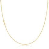 A yellow gold necklace with a pave letter I charm on a white background. 