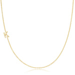 A yellow gold necklace with a pave letter K charm on a white background. 