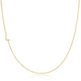 A yellow gold necklace with a pave letter L charm on a white background. 