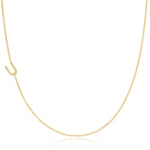 A yellow gold necklace with a pave letter U charm on a white background. 