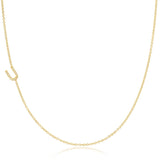 A yellow gold necklace with a pave letter U charm on a white background. 