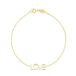 A yellow gold Love Bracelet on a white background. 