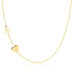 A Monogram Necklace with Heart Yellow Gold and a letter A charm on a white background.