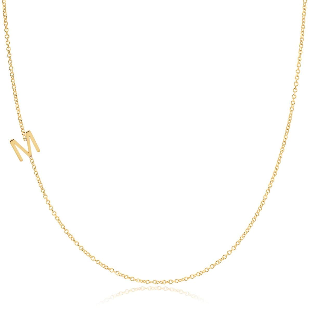 A yellow gold necklace with an M letter charm on a white background. 