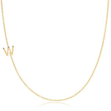 A yellow gold necklace with a W letter charm on a white background. 