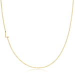 A yellow gold necklace with an L letter charm on a white background. 