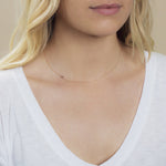 A yellow gold 14k Gold Asymmetrical Number Necklace - 5 on a white background. 