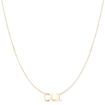 An OUI Necklace in yellow gold on a cable chain on a white background. 