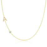 A Pavé Monogram Necklace with Diamond  and a letter A charm in yellow gold on a white background.