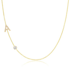 A Pavé Monogram Necklace with Diamond  and a letter A charm in yellow gold on a white background.