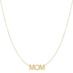 A Pavé MOM Necklace in yellow gold on a  cable chain on a white background. 