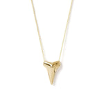 A Sharktooth Necklace in yellow gold on a white background. 