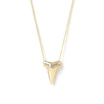 A Sharktooth Necklace with Diamond Ridge in yellow gold on a white background. 