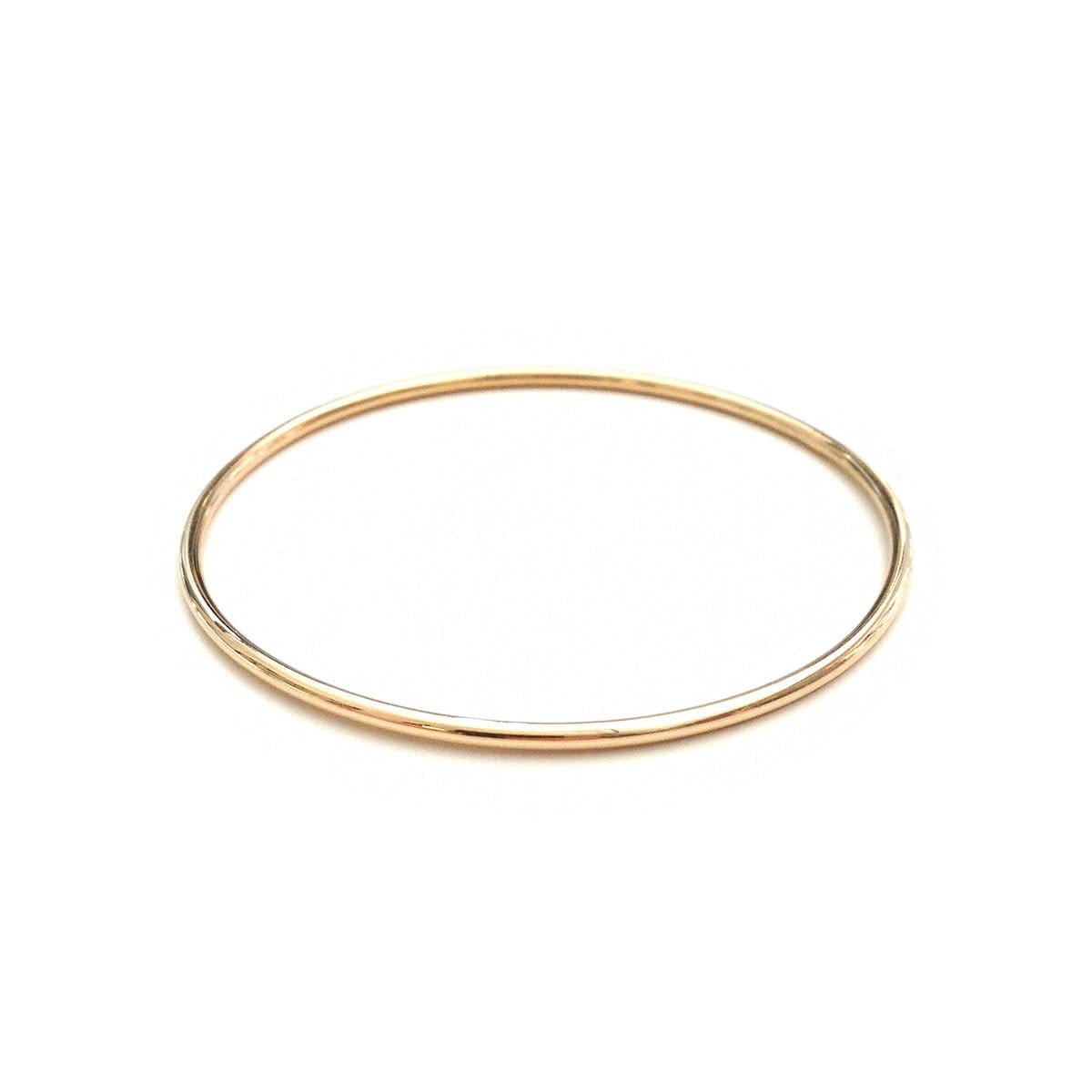 A yellow gold Simple Bangle on a white background. 