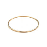 A yellow gold Simple Bangle on a white background. 