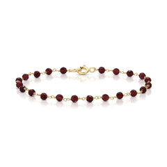 A bracelet featuring 3mm faceted garnet beads with 10k yellow gold wire and a large spring clasp closure.