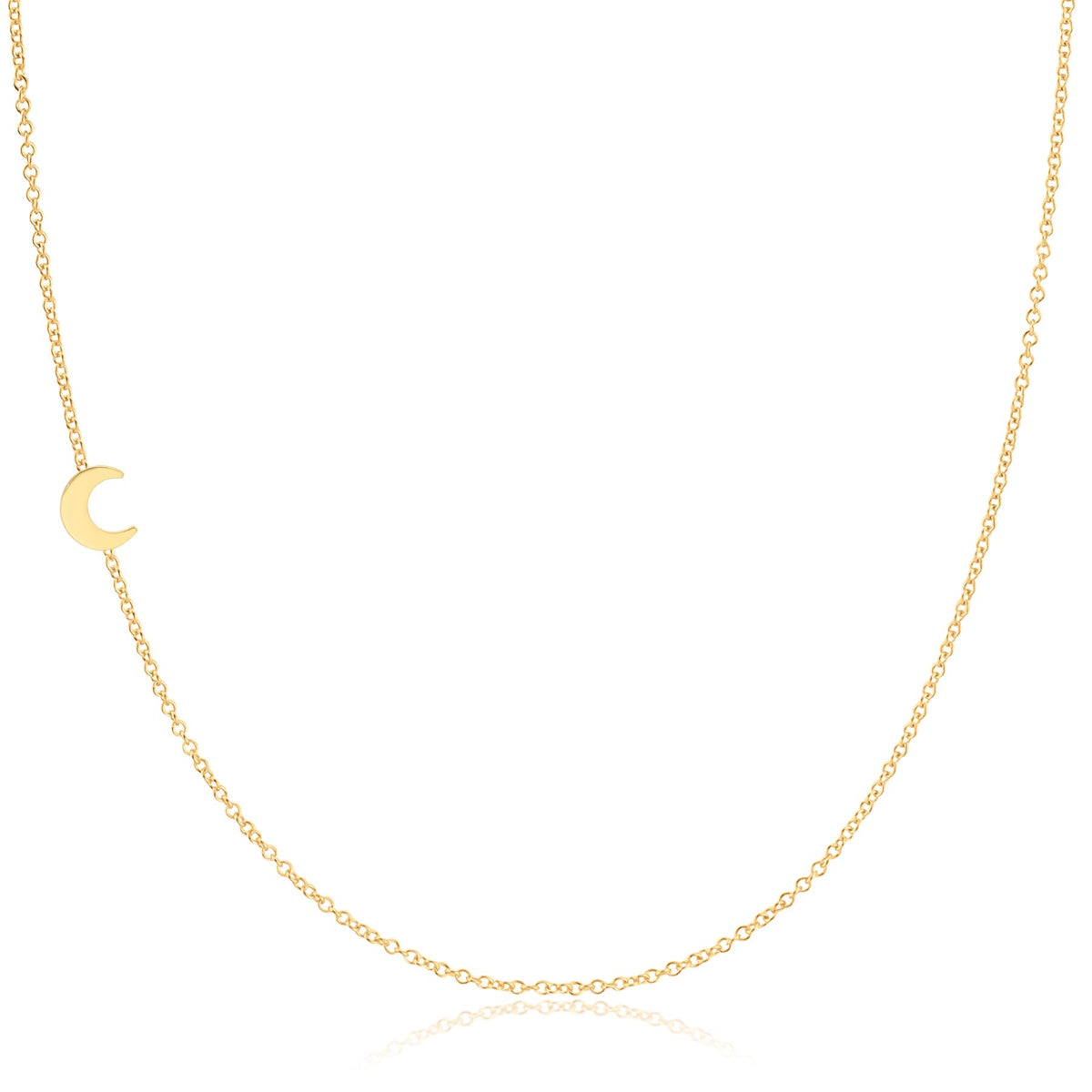A 14K gold asymmetrical charm necklace with a small crescent moon charm on a chain.