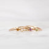 assorted birthstone rings on white blurred background