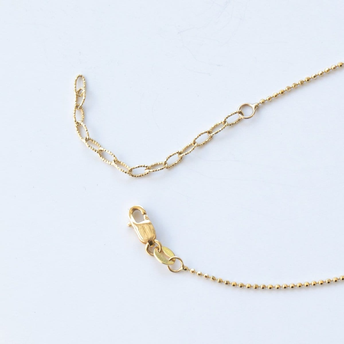 The back of a Stardust Diamond Necklace, showing the lobster clap on a white background. 