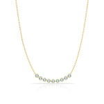 A Birthstone Arc Layering Necklace – Yellow Gold in Aquamarine – March on a white background.