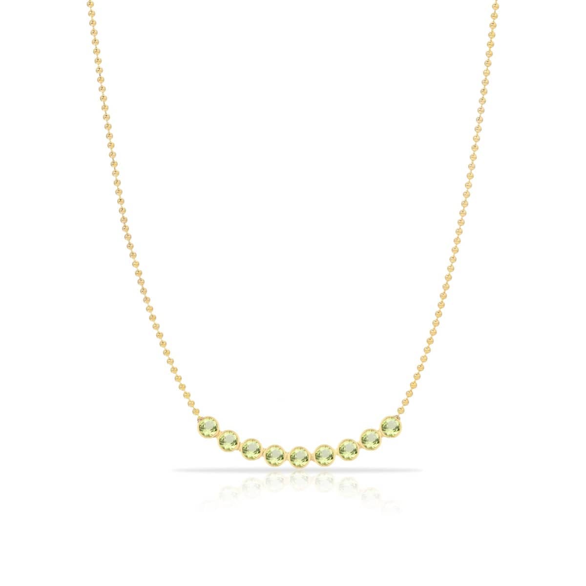 A Birthstone Arc Layering Necklace – Yellow Gold in Peridot – August on a white background.