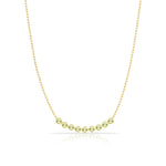 A Birthstone Arc Layering Necklace – Yellow Gold in Peridot – August on a white background.
