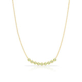 A Birthstone Arc Layering Necklace – Yellow Gold in Peridot – August on a white background.
