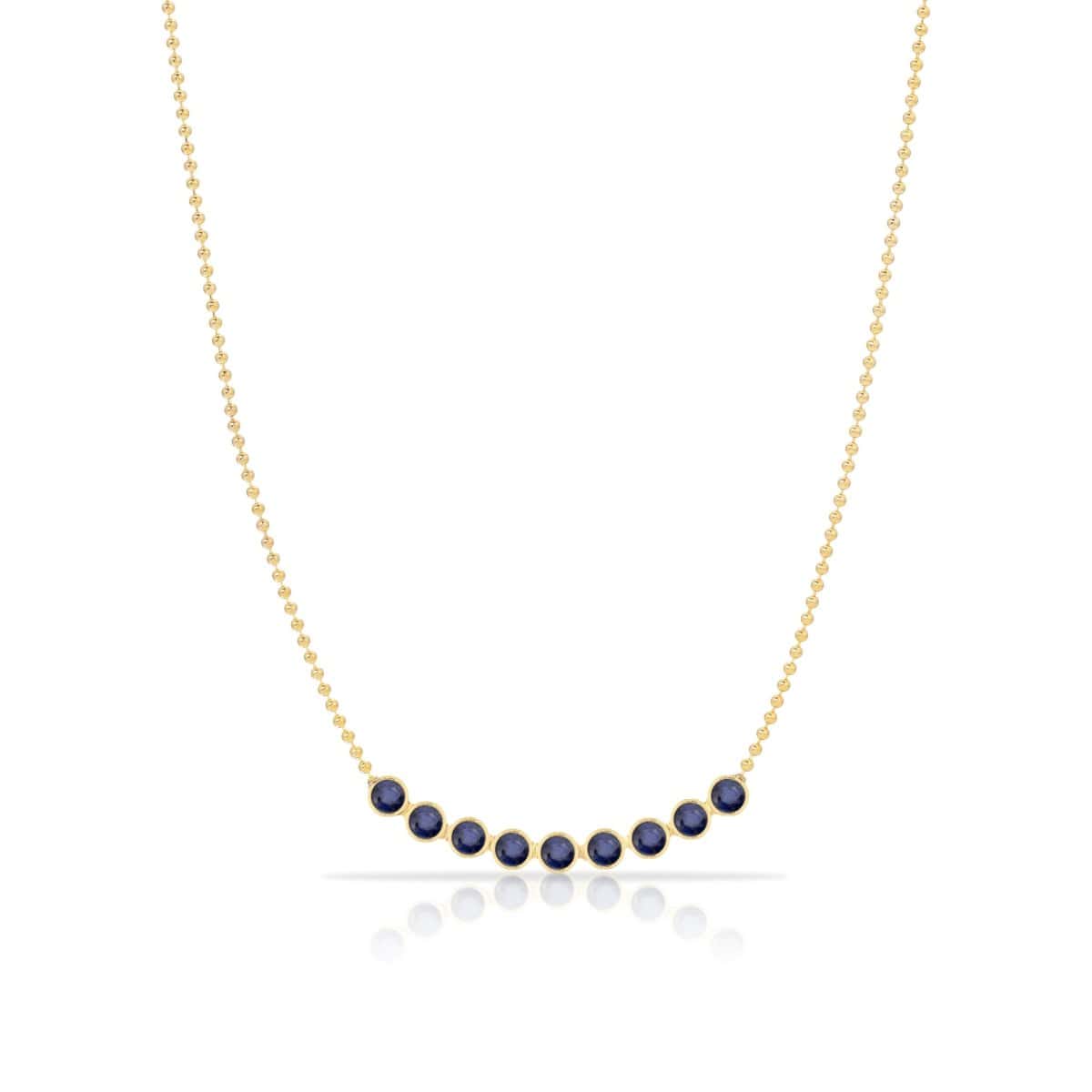 A Birthstone Arc Layering Necklace – Yellow Gold in Sapphire – September on a white background. 