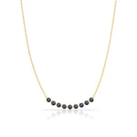 A Birthstone Arc Layering Necklace – Yellow Gold in Sapphire – September on a white background. 